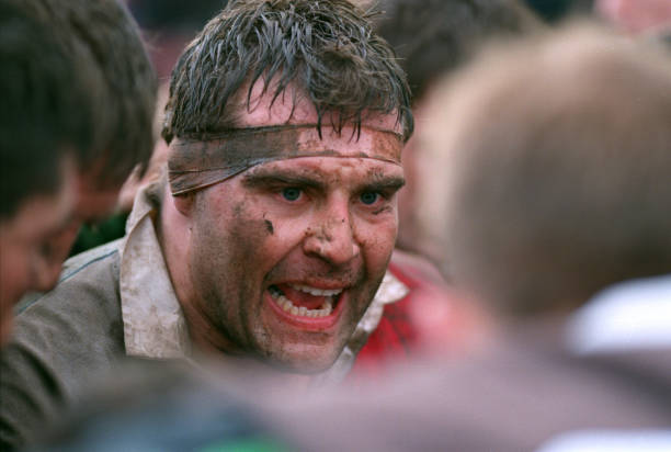 18 February 1997 - Rugby - Harlequins v Auckland - Harlequins captain Jason Leonard gives a team talk with a muddy face. (Photo by Mark Leech/Getty Images)