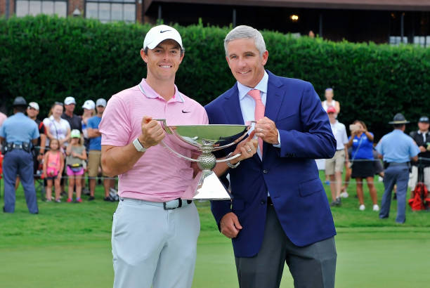 FedEx Cup winner Rory McIlroy holds the FedEx Cup trophy with PGA Commissioner Jay Monahan after the final round of the PGA Tour Championship on...