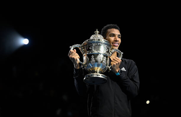 Felix Auger-Aliassime of Canada poses with the trophy after his final match against Holger Rune of Denmark during day nine of the Swiss Indoor Basel...