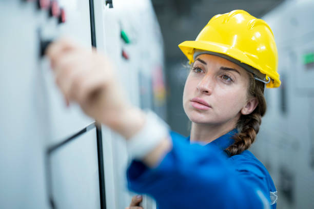 female electrician engineer working in control room are conduct process safety inspection of electricity distribution process in solar power plant. - eletricista  - fotografias e filmes do acervo