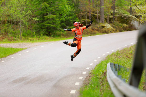 Female lumberjack jumping on forest road