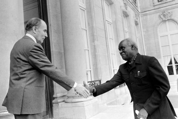 A file picture taken on March 28 1983 shows French President Francois Mitterrand shaking hands with Zambian President Kenneth Kaunda as he welcomes...