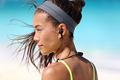 Fitness girl with sport in-ear wireless headphones