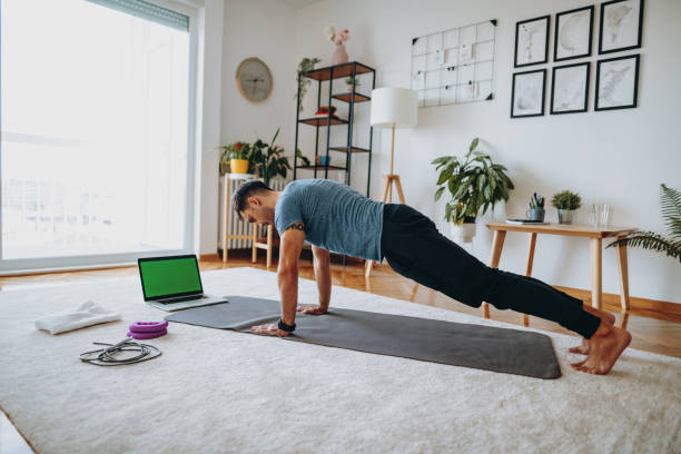 fitness instructor exercising push ups at home. vlogger showing how to exercise to loose weight - push ups stock pictures, royalty-free photos & images