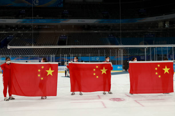 Flag bearer tidying up the national flag at the award ceremony during a Para Ice Hockey test event for the Beijing 2022 Winter Olympics at National...