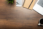 Flat lay of Office desk wooden table with laptop, and smartphone and equipment other office supplies
