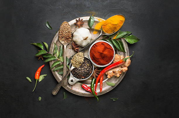 flat lay overhead view herb and spices on textured black background picture