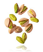Flying in air fresh raw whole and cracked pistachios
