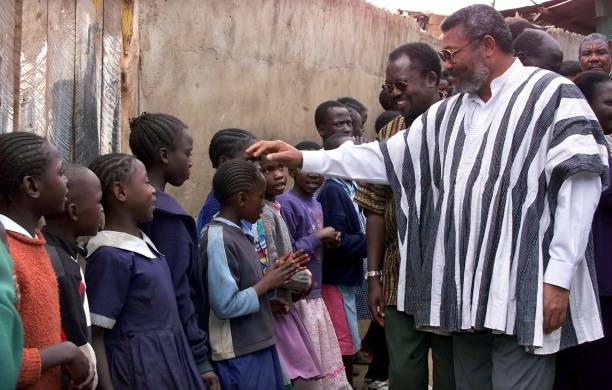 Former Ghanaian president Jerry Rawlings greets 29 September 2001 orphans at the Nyumbani Children's home in Nairobi Rawlings is in the country on a...