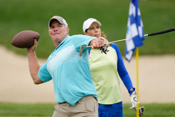 Former NFL player Brett Favre throws a football to a fan on the 14th green during the Celebrity Foursome at the second round of the American Family...