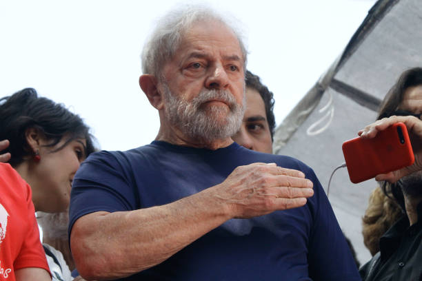 Former President Luiz Inacio Lula da Silva with impeached former president Dilma Rousseff gestures to supporters at the headquarters of the...
