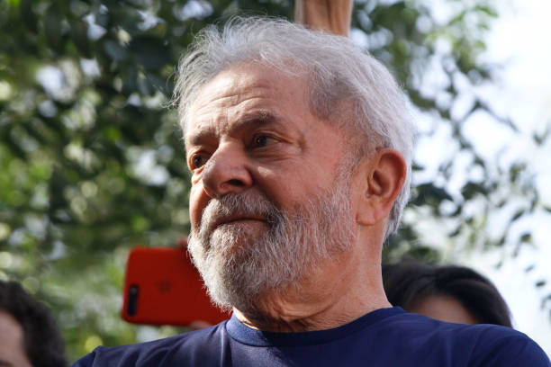 Former President Luiz Inacio Lula da Silva with impeached former president Dilma Rousseff gestures to supporters at the headquarters of the...