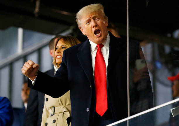 Former US President Donald Trump waves before the fourth game of the World Series between Houston Astros and Atlanta Braves ...