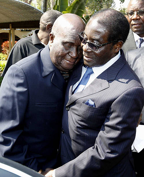 Former Zambia's first President Kenneth Kaunda embraces Zimbabwean President Robert Mugabe after a meeting at his office on August 3 2012 in Lusaka...