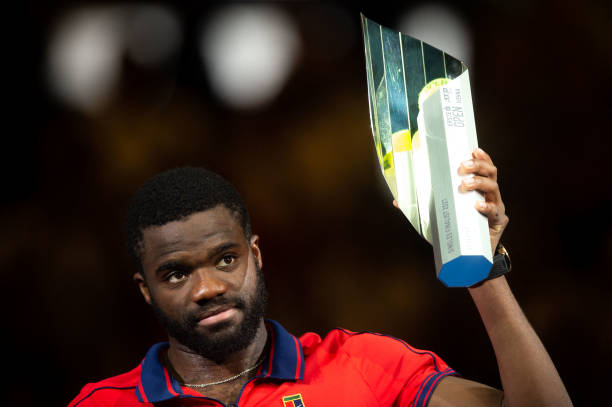 Frances Tiafoe from the US holds his trophy for the second place after the men's singles final match he lost against Germany's Alexander Zverev at...