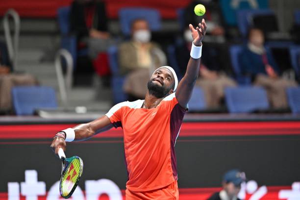 Frances Tiafoe of the US serves against Miomir Kecmanovic of Serbia during their men's singles quarter-final match at the Japan Open tennis...