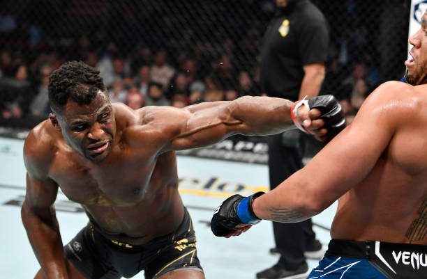 Francis Ngannou of Cameroon punches Ciryl Gane of France in their UFC heavyweight championship fight during the UFC 270 event at Honda Center on...
