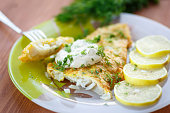 Fried fish with sliced lemons on the side