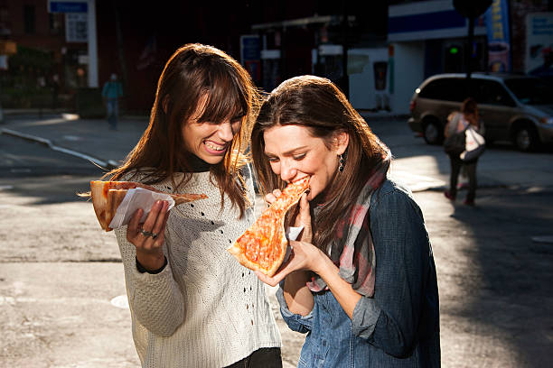 Friends grabbing a slice of pizza on the go