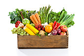 Fruits and veggies in wood box with white backdrop