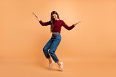 Full length side profile body size photo beautiful she her lady ideal appearance look dancing star queen hands arms raised wear casual red burgundy knitted pullover isolated pastel beige background