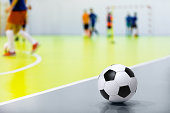 Futsal Background. Indoor Soccer Futsal Ball. Indoor Soccer Match in the Background. Futsal Sports Hall and Futsal Field. Youth Indoor Soccer League.