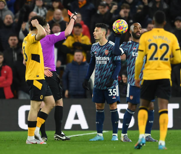 Gabriel Martinelli of Arsenal is shown the red card by Referee Michael Oliver during the Premier League match between Wolverhampton Wanderers and...