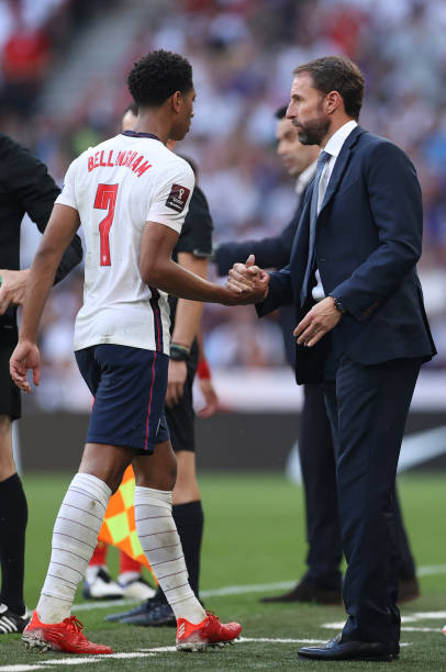 Gareth Southgate, Head Coach of England shakes hands with Jude Bellingham of England as he is substituted during the 2022 FIFA World Cup Qualifier...
