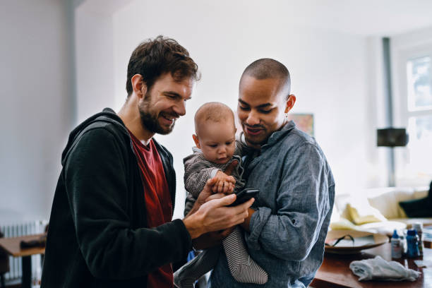 gay couple with their baby - gay black dads stock pictures, royalty-free photos & images