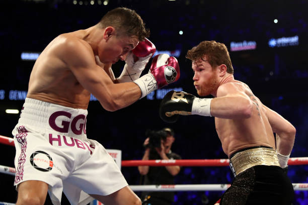 Gennady Golovkin and Canelo Alvarez exchange punches during their WBC/WBA middleweight title fight at T-Mobile Arena on September 15, 2018 in Las...