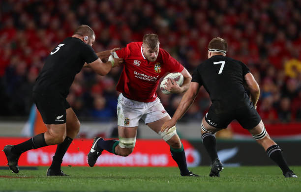 AUCKLAND, NEW ZEALAND - JUNE 24: George Kruis of the Lions is tackled by Owen Franks (L) and Sam Cane (R) of the All Blacks during the first test match between the New Zealand All Blacks and the British & Irish Lions at Eden Park on June 24, 2017 in Auckland, New Zealand. (Photo by David Rogers/Getty Images)