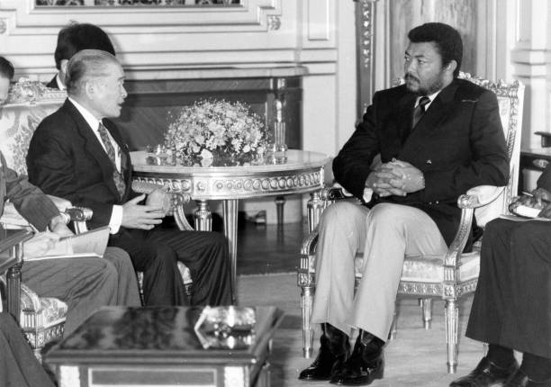 Ghana's Provisional National Defence Council Chairman Jerry John Rawlings talks with Japanese Prime Minister Noboru Takeshita during their meeting...