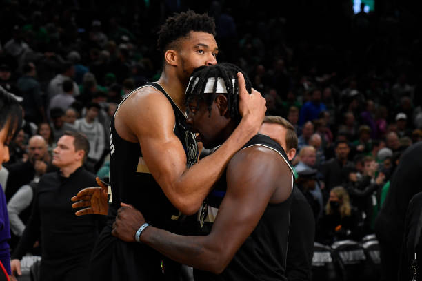 Giannis Antetokounmpo and Jrue Holiday of the Milwaukee Bucks embrace after the game against the Boston Celtics during Game 5 of the 2022 NBA...