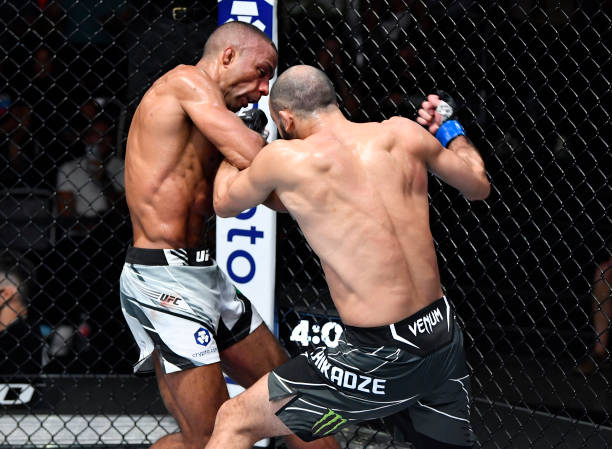 Giga Chikadze of Georgia punches Edson Barboza of Brazil in a featherweight fight during the UFC Fight Night event at UFC APEX on August 28, 2021 in...