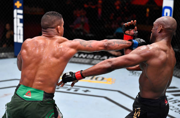 Gilbert Burns of Brazil punches Kamaru Usman of Nigeria in their UFC welterweight championship fight during the UFC 258 event at UFC APEX on February...