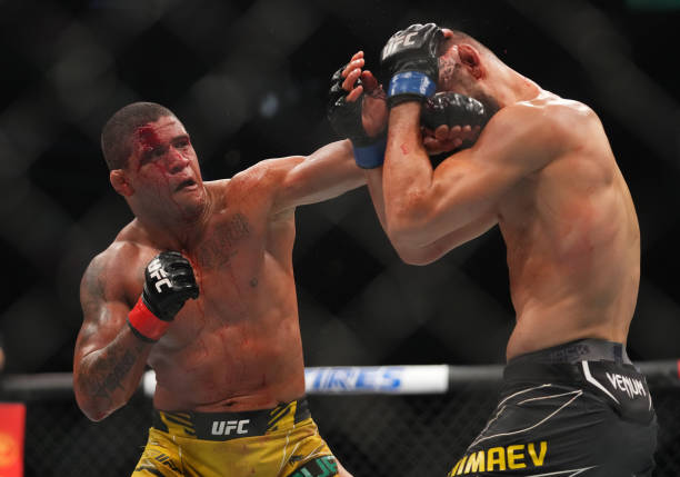 Gilbert Burns of Brazil punches Khamzat Chimaev of Russia in their welterweight fight during the UFC 273 event at VyStar Veterans Memorial Arena on...