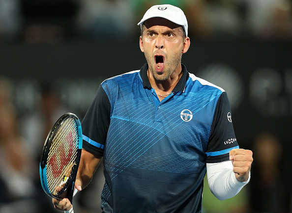 gilles-muller-of-luxembourg-celebrates-winning-set-point-in-his-picture-id903236236