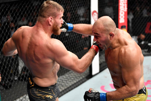 Glover Teixeira of Brazil and Jan Blachowicz of Poland trade punches in the UFC light heavyweight championship fight during the UFC 267 event at...