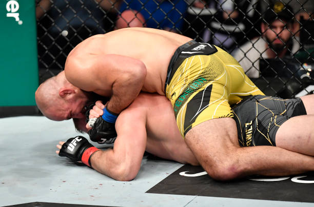 Glover Teixeira of Brazil secures a rear choke submission against Jan Blachowicz of Poland in the UFC light heavyweight championship fight during the...