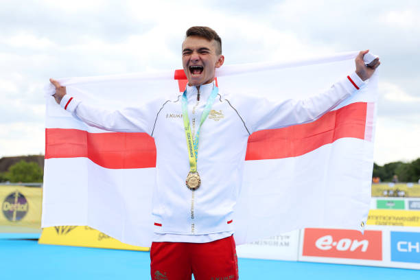Gold medallist Alex Yee of Team England celebrate during the Men's Individual Sprint Distance Triathlon medal ceremony on day one of the Birmingham...