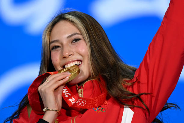 Gold medallist China's Gu Ailing Eileen celebrates on the podium during the freestyle skiing women's freeski big air victory ceremony at the Beijing...