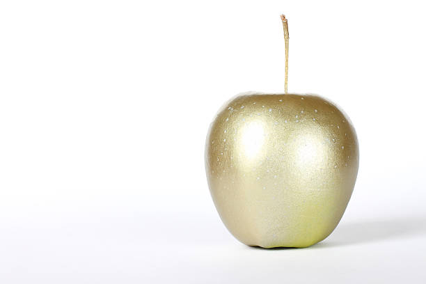 a golden apple - golden apple stock pictures, royalty-free photos & images