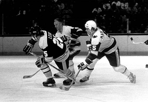 gordie-howe-and-son-mark-howe-of-the-new-england-whalers-skate-on-the-picture-id53126795