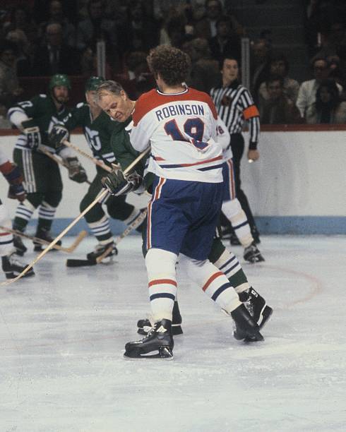 gordie-howe-of-the-hartford-whalers-skates-against-larry-robinson-of-picture-id99884232