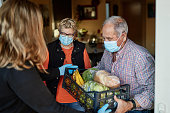 Grandchild delivers groceries to grandparents during pandemic at their home