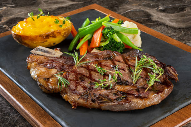 grilled steak with prepared potato and steamed vegetables picture