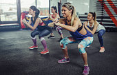 Group of athlete women exercising at the gym. Fitness women exercising at gym.