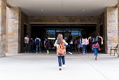 Group of student walking into school building