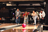 Group of young people having fun in a bowling alley