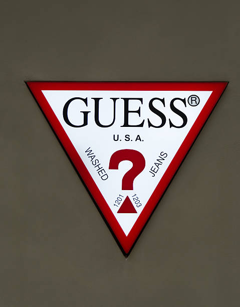 Guess Logo on wall: White triangle with red border and black ...